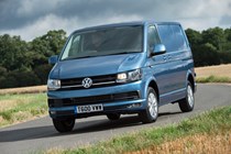Image of a blue Volkswagen Transporter driving round a corner, viewed from the front left corner