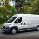 Image of a silver Fiat Ducato driving on a country road, viewed from the left side