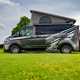 Image of a Ford Transit Custom MS-RT Wellhouse campervan, with roof raised, viewed from the left side
