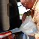 Image of a man filling a Volkswagen California's water tank