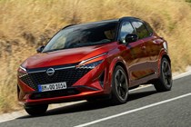 Nissan Qashqai (2025) review: front three quarter cornering, red paint, low angle