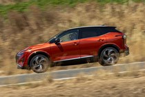 Nissan Qashqai (2025) review: side view driving, red paint