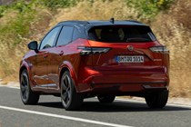 Nissan Qashqai (2025) review: rear three quarter driving, red paint