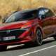 Nissan Qashqai (2025) review: front three quarter cornering, red paint, low angle