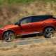 Nissan Qashqai (2025) review: side view driving, red paint