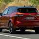 Nissan Qashqai (2025) review: rear three quarter driving, red paint