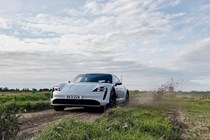 Porsche Taycan Cross Turismo review - front view, driving, splashing through mud