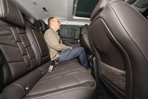 Image of the DS 4 back seat, with writer Graham King sat demonstrating the space