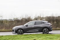 Image of the DS 4, in grey, viewed from the left side while driving