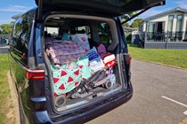 VW Multivan review, blue eHybrid, boot space filled with pushchair and other holiday luggage, Bauer exclusive image