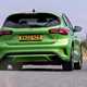 Ford Focus ST review, facelift, Mean Green, rear view, driving round corner
