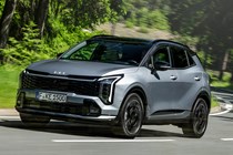 Kia Sportage review, silver, moving, front three quarters (2025)
