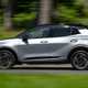 Kia Sportage review, silver, moving, side (2025)