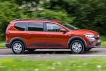 Dacia Jogger (2023) review: side view driving, fly-by, country lane, orange paint