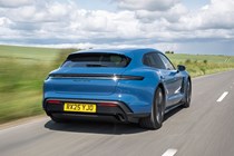 Porsche Taycan Sport Turismo (2025) review: rear three quarter driving, blue paint