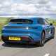Porsche Taycan Sport Turismo (2025) review: rear three quarter driving, blue paint