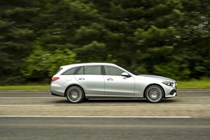 Image of a silver Mercedes C-Class estate, viewed from the right side while driving