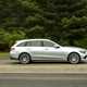 Image of a silver Mercedes C-Class estate, viewed from the right side while driving