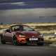 Image of a red Mazda MX-5, viewed from the front right corner while going round a corner
