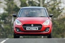 Suzuki Swift (2023) review: front driving, red paint, rural background