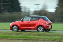 Suzuki Swift (2023) review: pan shot, red paint, rural background