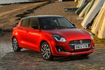 Suzuki Swift (2023) review: front three quarter static, on the beach, red paint