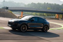 Porsche Cayenne Coupe review - 2023 facelift - Turbo E-Hybrid with GT Package, side, blue and gold, driving round corner on racing circuit