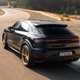 Porsche Cayenne Coupe review - 2023 facelift - Turbo E-Hybrid with GT Package, rear, blue and gold, driving round corner on racing circuit