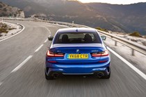 BMW 3 Series review - dead-on rear view, blue, driving