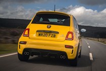 Abarth 595 (2022) review: rear three quarter driving, yellow car, wooded lane
