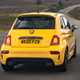 Abarth 595 (2022) review: rear three quarter driving shot, yellow car