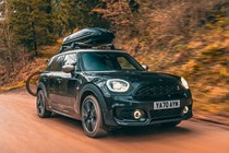 MINI Countryman (2023) review: front three quarter tracking shot, off-road driving, black paint