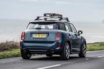 MINI Countryman (2023) review: rear static, surfboard on roof, blue paint, sea in background