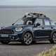 MINI Countryman (2023) review: front three quarter static, surfboard on roof, blue paint, sea in background