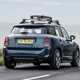 MINI Countryman (2023) review: rear static, surfboard on roof, blue paint, sea in background