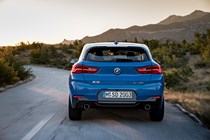 BMW 2018 X2 (lhd) in blue rear shot driving/action