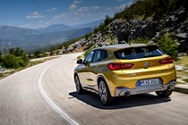 BMW 2018 X2 (lhd) in yellow/gold rear three-quarters driving/action