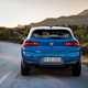 BMW 2018 X2 (lhd) in blue rear shot driving/action