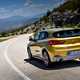 BMW 2018 X2 (lhd) in yellow/gold rear three-quarters driving/action