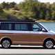 VW California review - 2019 T6.1 model, side view  with door and awning, driving, two-tone paint