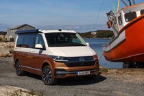 VW California review - 2019 T6.1 model, front view parked next to boat, two-tone paint