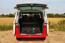 VW Caravelle, rear view with hatchback open showing boot, red and white Generation Six model