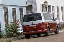 VW Caravelle review - T6.1 facelift, 2019, red and silver, rear view next to building