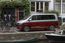 VW Caravelle review - T6.1 facelift, 2019, red and silver, side view by canal, boats and bicycles