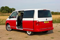 VW Caravelle T6, Generation Six, red and white, rear view, side door open
