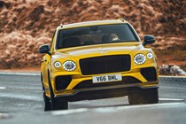 Bentley Bentayga review - 2022 Hybrid S, yellow, front view, driving round corner