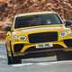 Bentley Bentayga review - 2022 Hybrid S, yellow, front view, driving round corner