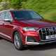 Audi SQ7 review (2022) - front three quarter rolling shot, red car, leafy road