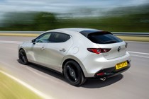 Mazda 3 (2023) review: rear three quarter cornering, long exposure, silver paint, country lane