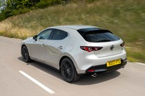 Mazda 3 (2023) review: rear three quarter driving, silver paint, country lane